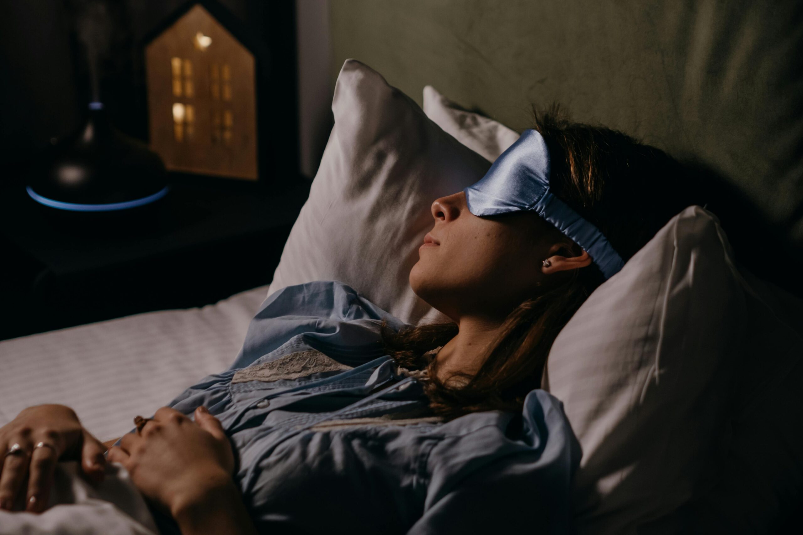 Woman sleeping with eye mask in bed